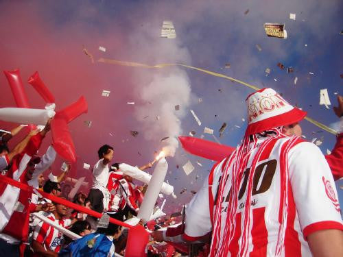 Football fans celebrating during a match in Argentina