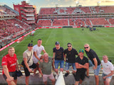 Group of matchday experience guests posing for a photo at Independiente's soccer stadium