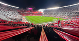 A full Monumental stadium in Buenos Aires covered in banners and flares welcoming the River Plate players onto the pitch