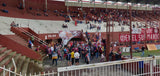 Lanús fans chanting and waving red and white flags